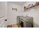 Efficient laundry room with modern washer and dryer units and storage shelving at 3876 Thackary Dr, Powder Springs, GA 30127