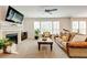 Bright living room with a fireplace, plush carpet, and large windows that provide natural light at 3876 Thackary Dr, Powder Springs, GA 30127