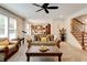 Inviting living room showcases large windows, comfortable seating, and open flow to the kitchen and dining area at 3876 Thackary Dr, Powder Springs, GA 30127