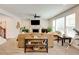 Spacious living room features neutral carpet, a fireplace, large windows, and ample seating at 3876 Thackary Dr, Powder Springs, GA 30127