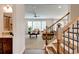 Staircase view of a living room featuring neutral carpet, large windows and comfortable leather sofas at 3876 Thackary Dr, Powder Springs, GA 30127
