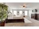 Bright main bedroom features a large bed, ceiling fan, and multiple windows for natural light at 3876 Thackary Dr, Powder Springs, GA 30127