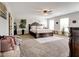 Spacious main bedroom with a ceiling fan, a large window, and a king-size bed at 3876 Thackary Dr, Powder Springs, GA 30127