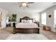 Cozy main bedroom with a large, decorative bed, ceiling fan, and natural light at 3876 Thackary Dr, Powder Springs, GA 30127