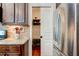Functional walk-in pantry adjacent to kitchen, complete with shelving and stainless fridge at 3876 Thackary Dr, Powder Springs, GA 30127