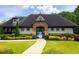 Charming pool house with brick accents, manicured landscaping, and a gated entrance leading to a refreshing swimming pool at 3876 Thackary Dr, Powder Springs, GA 30127
