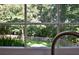 Kitchen window view overlooking fenced-in backyard and lush green trees at 5040 Puritan Dr, Sugar Hill, GA 30518