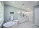 Bright bathroom featuring a soaking tub, double vanity, and marble floor at 5040 Puritan Dr, Sugar Hill, GA 30518