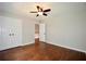 Bedroom featuring hardwood floors, a ceiling fan, and a closet at 5040 Puritan Dr, Sugar Hill, GA 30518