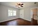 Bedroom featuring hardwood floors, a ceiling fan, and a closet at 5040 Puritan Dr, Sugar Hill, GA 30518