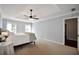 Bedroom with king bed, ceiling fan, two windows, and neutral carpeting at 5040 Puritan Dr, Sugar Hill, GA 30518