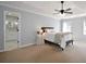 Bedroom with king bed, two windows, ceiling fan and attached bathroom at 5040 Puritan Dr, Sugar Hill, GA 30518