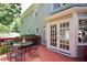 Inviting outdoor deck with glass table, chairs, and double doors leading indoors at 5040 Puritan Dr, Sugar Hill, GA 30518