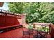 Outdoor deck area featuring a glass table, bench and chairs, perfect for outdoor enjoyment at 5040 Puritan Dr, Sugar Hill, GA 30518