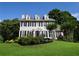 Charming two-story home featuring gray siding, black shutters, dormer windows, and a well-manicured front lawn at 5040 Puritan Dr, Sugar Hill, GA 30518