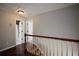 Hallway with staircase and two doors, one leading to a bathroom at 5040 Puritan Dr, Sugar Hill, GA 30518