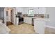 Charming kitchen features stainless steel appliances, white cabinets, and stylish backsplash at 5040 Puritan Dr, Sugar Hill, GA 30518