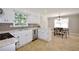 Charming kitchen features white cabinets, stainless steel appliances, and eat-in dining space at 5040 Puritan Dr, Sugar Hill, GA 30518