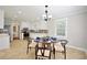 Bright eat-in kitchen with white cabinets, stainless steel appliances, and modern decor at 5040 Puritan Dr, Sugar Hill, GA 30518