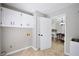 Clean laundry room with ample storage cabinets and easy access to dining area at 5040 Puritan Dr, Sugar Hill, GA 30518
