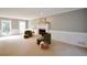 Spacious living room offering a cozy fireplace, comfortable seating, neutral carpet, and multiple windows for natural light at 5040 Puritan Dr, Sugar Hill, GA 30518