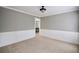 Neutral living space features gray walls and crisp, white wainscoting at 5040 Puritan Dr, Sugar Hill, GA 30518