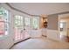 Cozy sitting area with french doors leading to a deck, featuring a bar area and lots of natural light at 5040 Puritan Dr, Sugar Hill, GA 30518