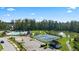 Aerial view of neighborhood amenities, including a pool, tennis courts, pond, and playground at 566 Silver Moon Dr, Loganville, GA 30052