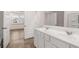 Bright bathroom with double sink vanity and view into the bedroom with large windows at 566 Silver Moon Dr, Loganville, GA 30052