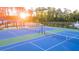 Bright blue and green tennis courts sit next to a pond at this community's sport and recreation center at 566 Silver Moon Dr, Loganville, GA 30052