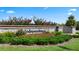 Attractive community entrance with brick and stone sign, manicured landscaping, and seasonal flowers at 577 Silver Moon Dr, Loganville, GA 30052
