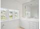 Bright all-white bathroom with ample natural light, window, and custom vanity at 1640 Kenai Rd, Kennesaw, GA 30152