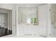 Elegant white bathroom featuring a large mirror, dual vanities, and a glass shower at 1640 Kenai Rd, Kennesaw, GA 30152