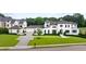 Grand home with manicured front lawn and a driveway leading to an attached three car garage at 1640 Kenai Rd, Kennesaw, GA 30152