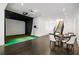 Spacious game room featuring a golf simulator, table and chairs, and staircase at 1640 Kenai Rd, Kennesaw, GA 30152