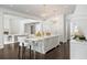 Elegant, all-white kitchen with a spacious island and chandelier lighting at 1640 Kenai Rd, Kennesaw, GA 30152