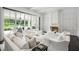 Open living room with a fireplace, white furniture, and seamless indoor/outdoor living at 1640 Kenai Rd, Kennesaw, GA 30152