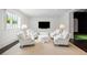 Comfortable living room with plush white armchairs, natural light, and entertainment area at 1640 Kenai Rd, Kennesaw, GA 30152