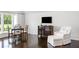 Sitting area features hardwood floors, natural light, comfortable seating and a TV at 1640 Kenai Rd, Kennesaw, GA 30152