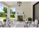 Comfortable outdoor patio with seating, a fireplace, and a view of the well-manicured lawn at 1640 Kenai Rd, Kennesaw, GA 30152