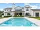 Stunning home features a sparkling pool with a covered patio and beautiful backyard landscaping at 1640 Kenai Rd, Kennesaw, GA 30152