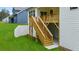 Exterior view featuring wooden stairs leading to a deck with a well-manicured lawn at 51 Black Rock Rdg, Sharpsburg, GA 30277