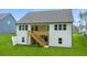 Back exterior view featuring a deck with stairs and a spacious green lawn at 51 Black Rock Rdg, Sharpsburg, GA 30277