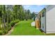 Expansive backyard featuring a lush lawn and wooden staircase leading to a deck at 51 Black Rock Rdg, Sharpsburg, GA 30277