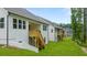 A view of multiple homes featuring wooden stairs leading to a deck, with a spacious backyard at 51 Black Rock Rdg, Sharpsburg, GA 30277