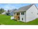 Home's rear exterior showcases a deck with stairs and a well-manicured lawn at 51 Black Rock Rdg, Sharpsburg, GA 30277