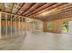Spacious unfinished basement with exposed beams, concrete floor, framed walls and an exterior door to the backyard at 51 Black Rock Rdg, Sharpsburg, GA 30277