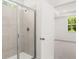Bathroom featuring a glass-enclosed shower with tile surround and a view to the bedroom at 51 Black Rock Rdg, Sharpsburg, GA 30277