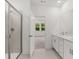 Bright bathroom featuring double sinks, quartz countertops, and a glass-enclosed shower at 51 Black Rock Rdg, Sharpsburg, GA 30277