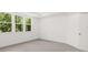 Bedroom features natural lighting from the large window and neutral carpet at 51 Black Rock Rdg, Sharpsburg, GA 30277